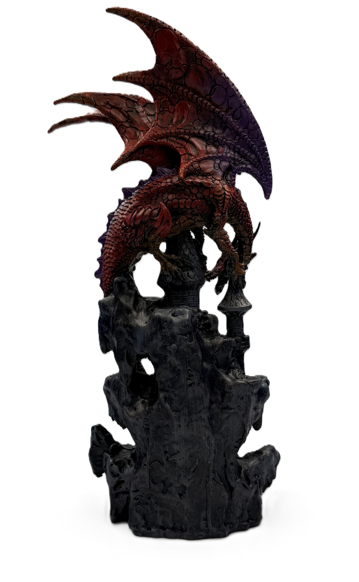 Rear view of dragon castle statue showing textured wings, tail, and fortress base details in dark finish
