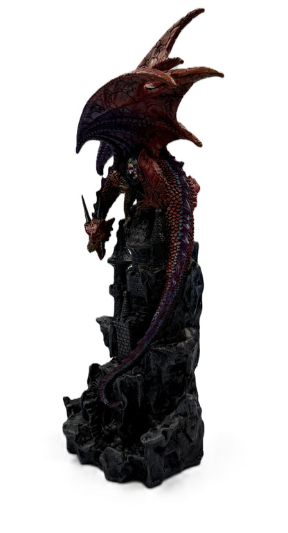 Side angled view of hand painted red dragon wrapped around medieval castle tower with extended wings
