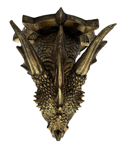 Top view of dragon head plaque highlighting horns and textured surface
