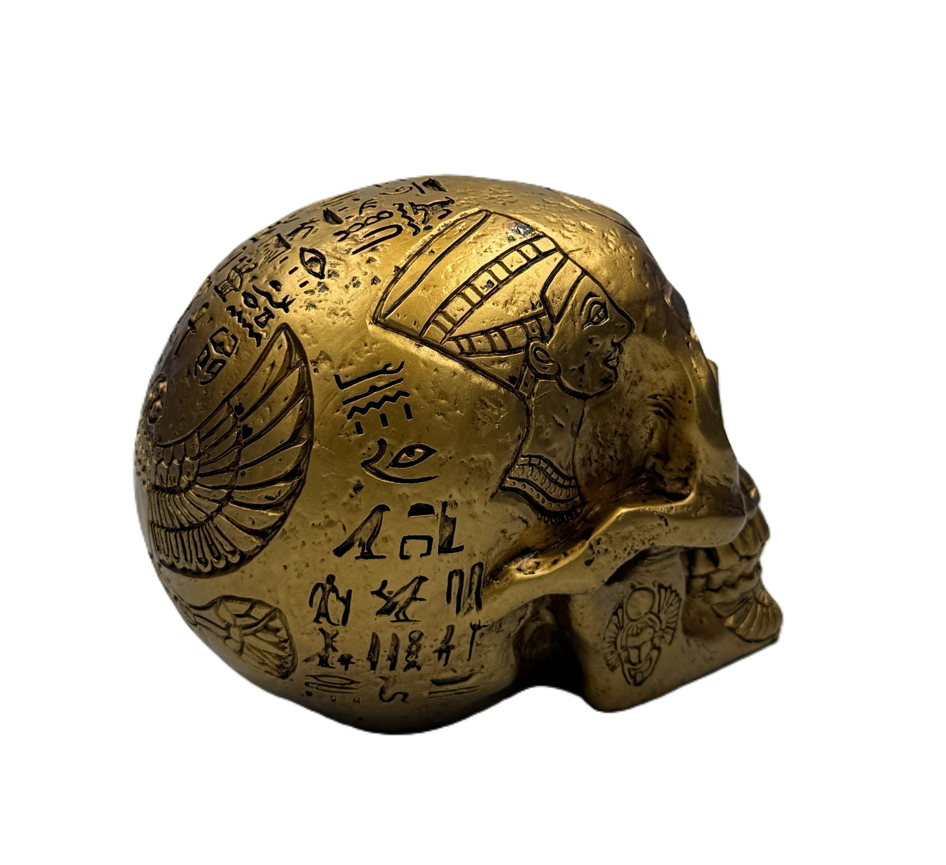 Rear side view of Egyptian skull statue showing winged scarab motif and detailed carved hieroglyphs
