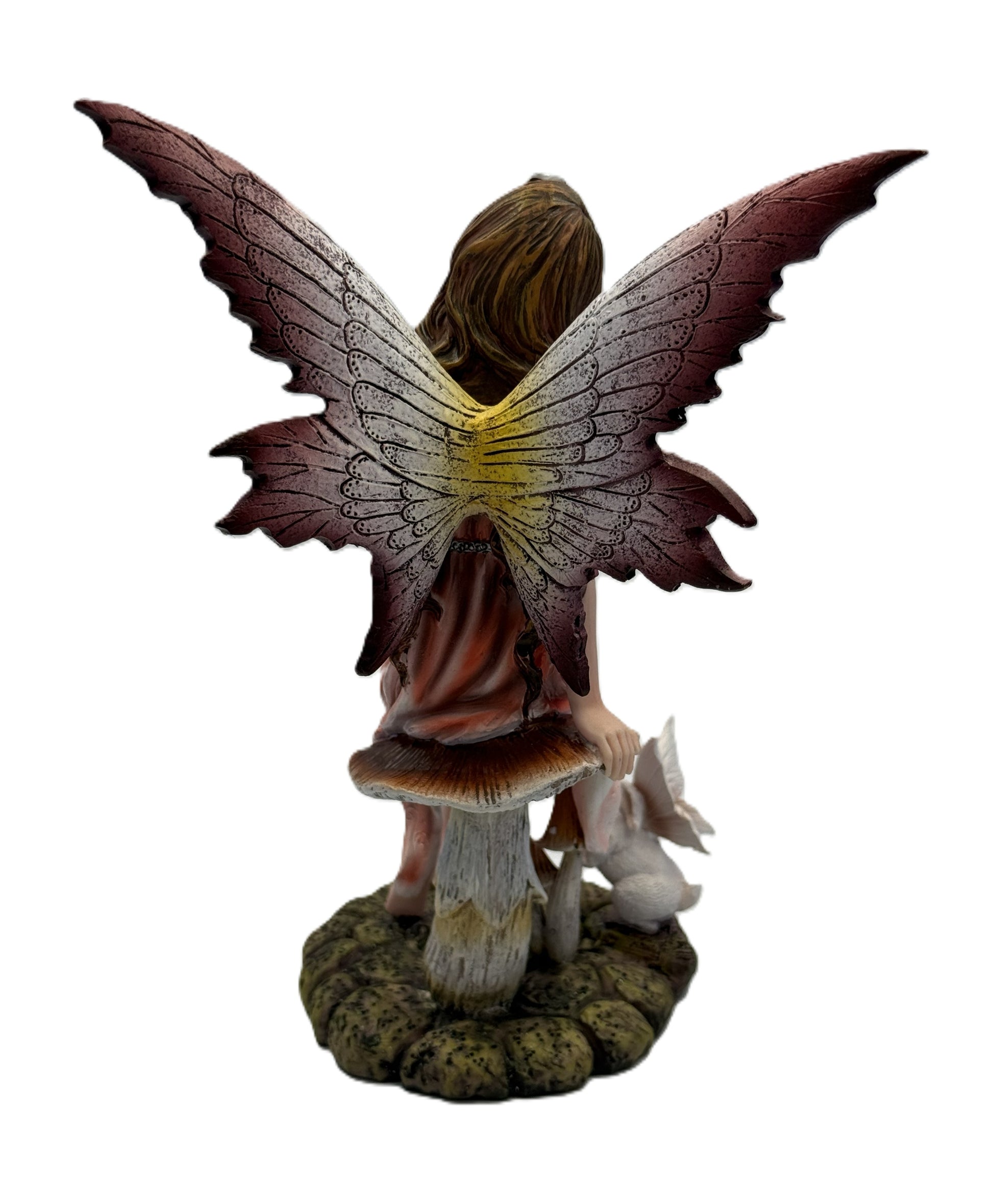 Back view of fairy statue highlighting large textured wings and woodland base with rabbit figure
