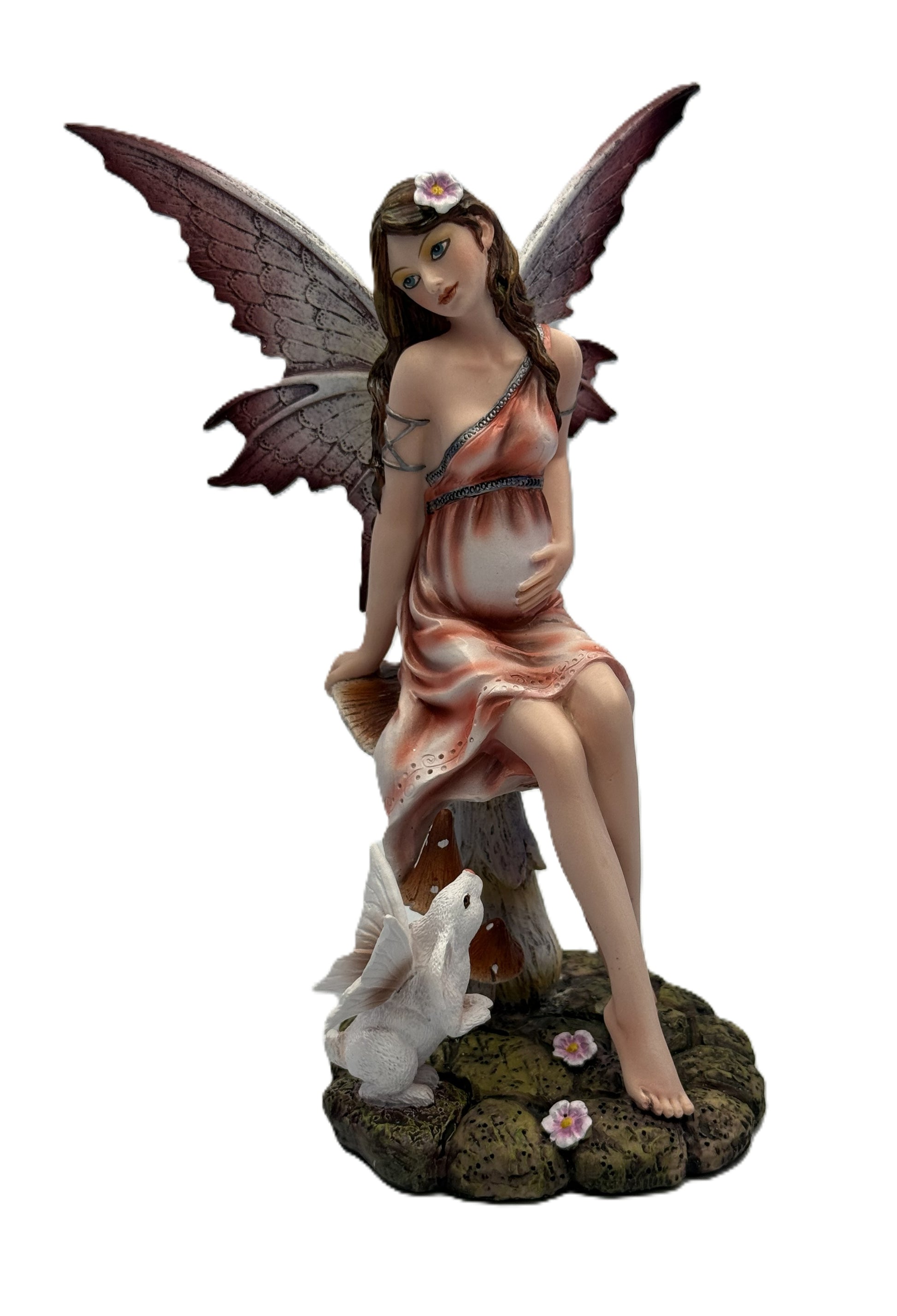Front view of expecting fairy resin statue sitting on mushroom with butterfly wings and small rabbit companion

