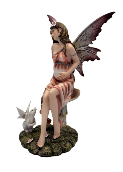 Side front view of pregnant fairy figurine with flowing dress delicate wings and woodland base details
