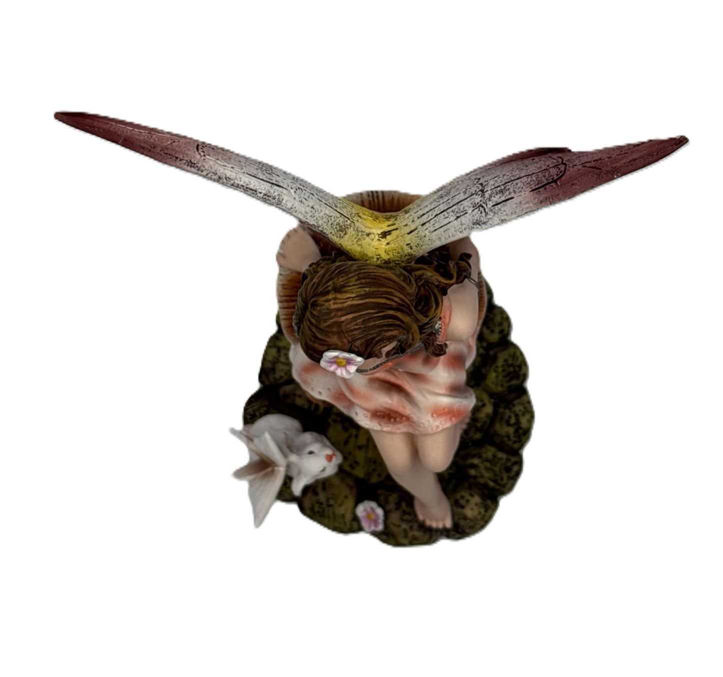 Top view of fairy resin statue showing wing spread hairstyle flower detail and sculpted base
