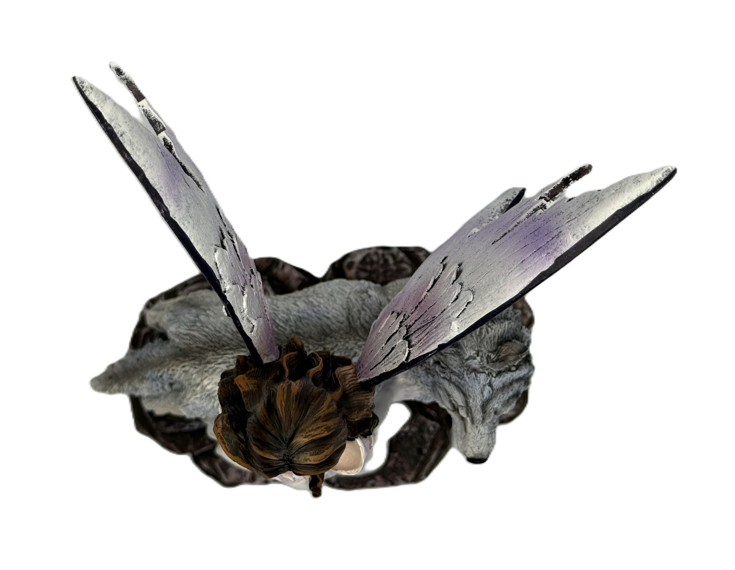 Top view of fairy and wolf sculpture highlighting wing span and base design
