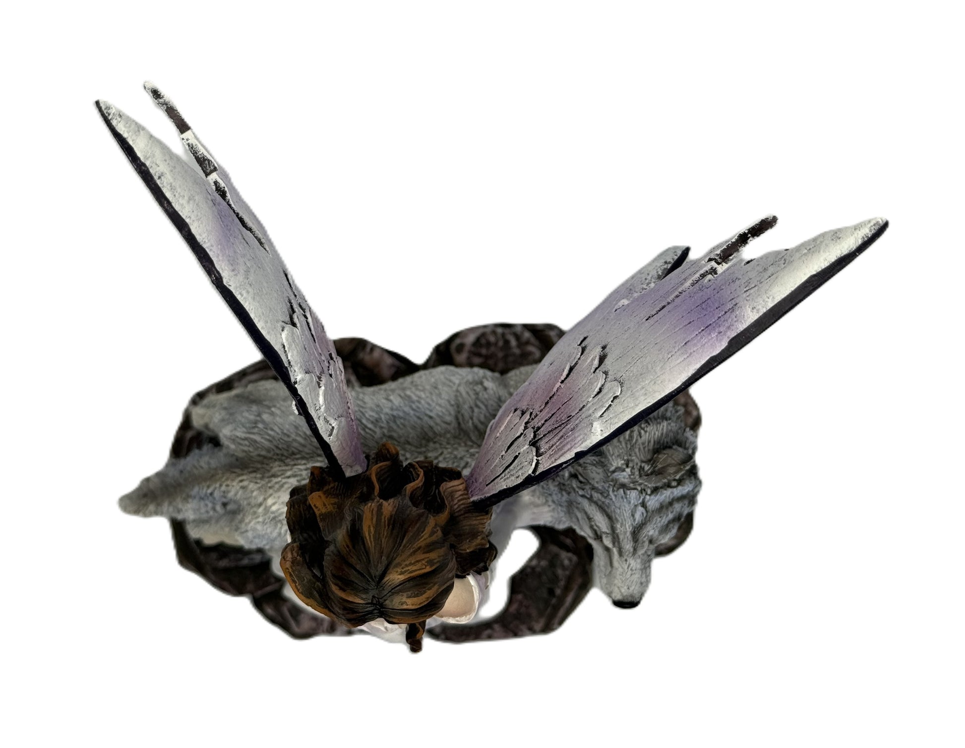 Top view of fairy and wolf sculpture highlighting wing span and base design
