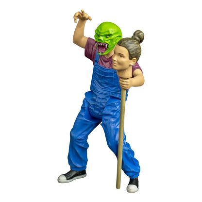 Angled view of Goosebumps The Haunted Mask action figure showing the green mask, blue overalls and head-on-a-stick accessory.