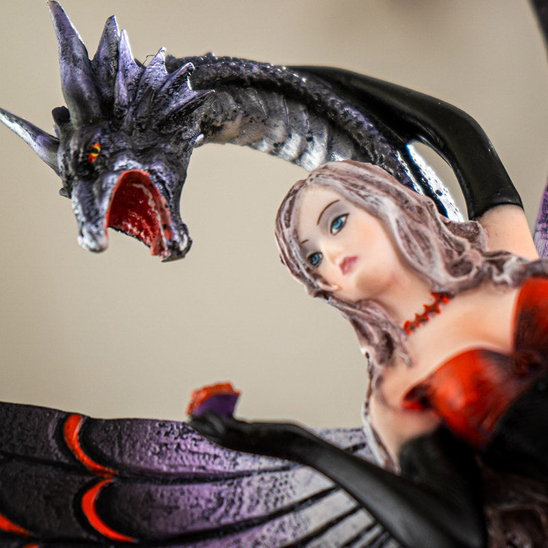 Close up of fairy and dragon statue showing facial details and dragon head
