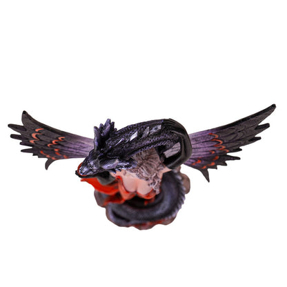 Top view of fantasy fairy statue with dragon wrapped around figure and wings extended
