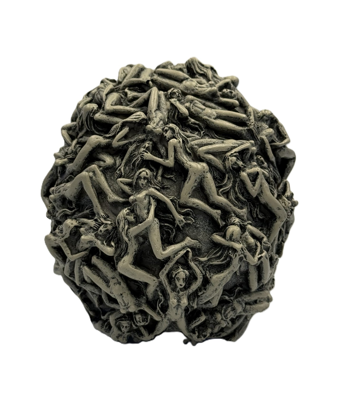 Back view of skull statue showing dense arrangement of intertwined figures covering the entire surface
