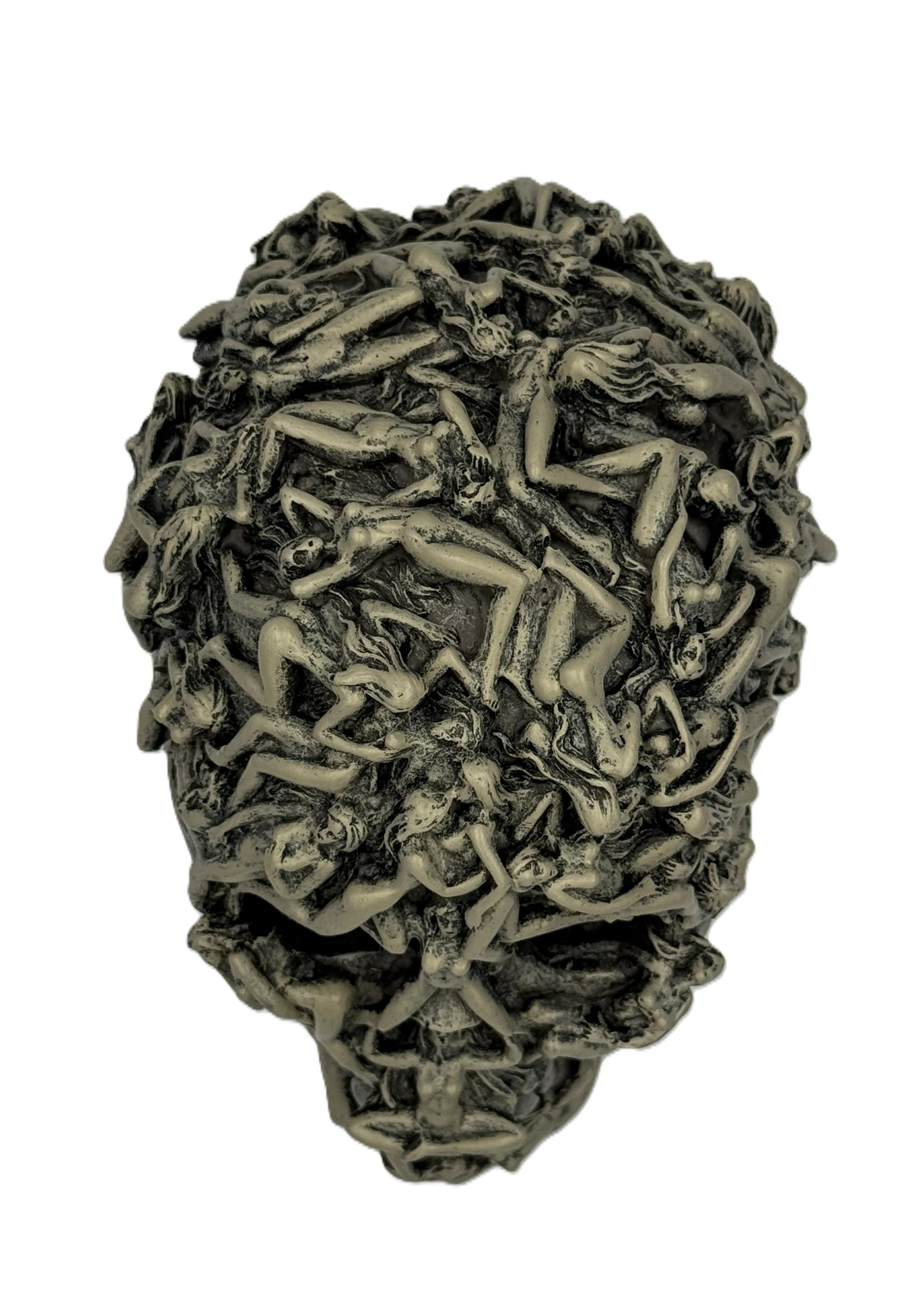 Overhead close view of gothic skull sculpture highlighting tightly packed intertwined human forms
