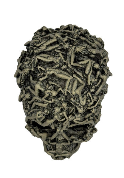 Overhead close view of gothic skull sculpture highlighting tightly packed intertwined human forms
