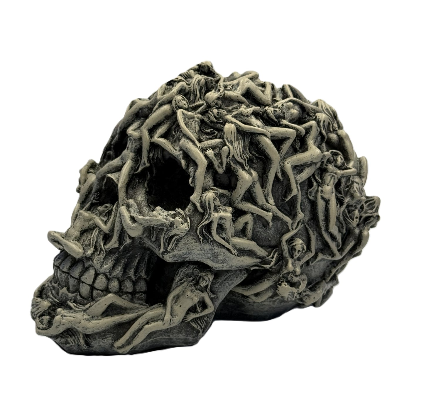 Left side view of skull sculpture showing layered intertwined figures across the surface
