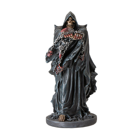Front view of grim reaper statue holding chains with skull details and gothic cloak
