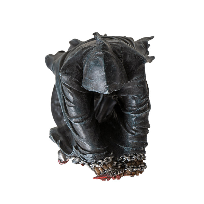 Top view of grim reaper statue showing hood and chained hands detail
