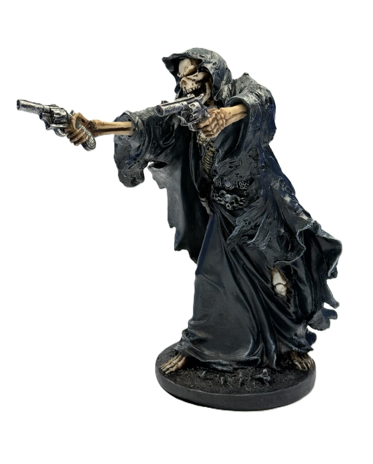 Front angled view of gunslinger grim reaper statue holding dual revolvers with detailed skeletal face and flowing hooded robe
