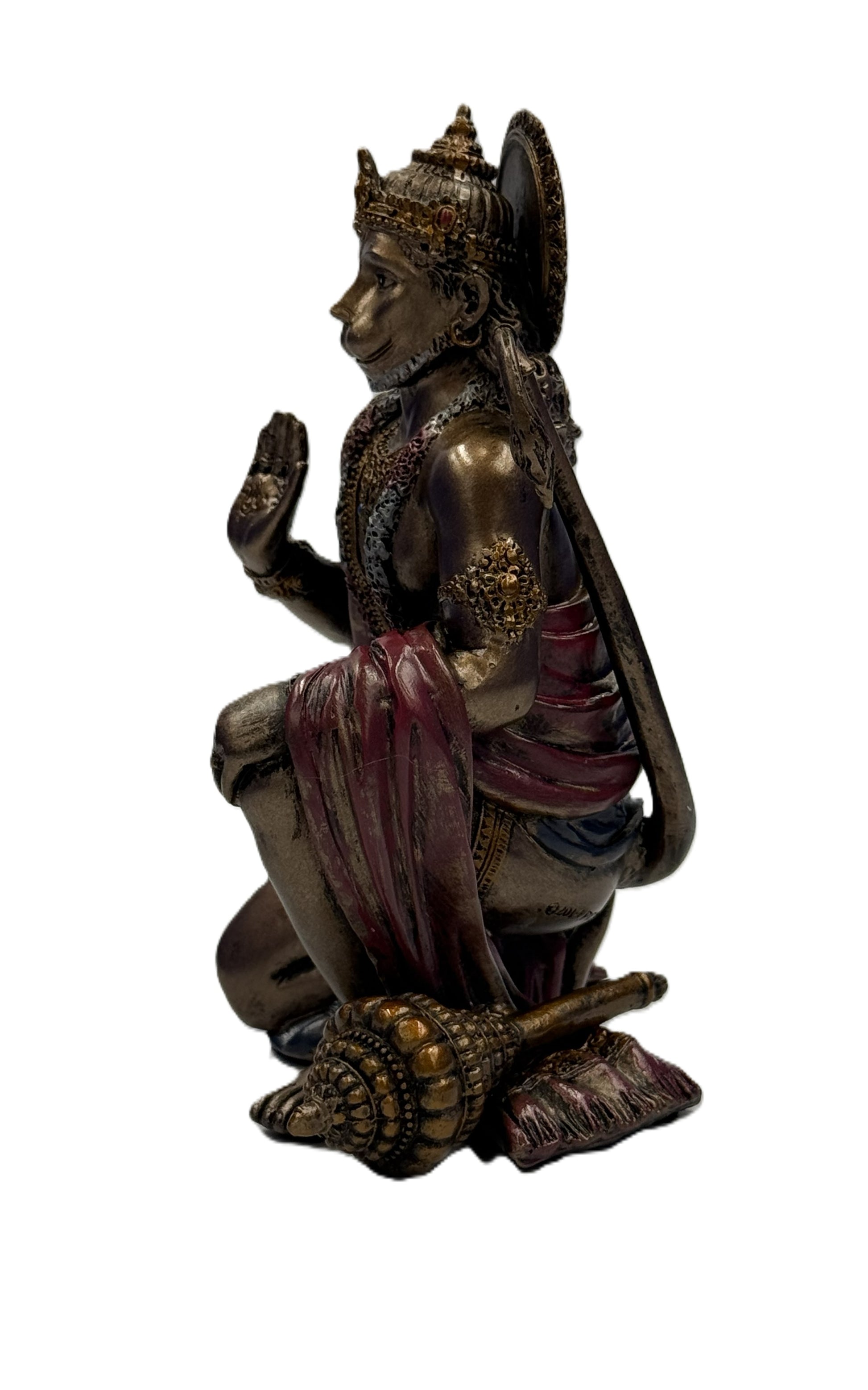 Side profile of Hanuman statue showing detailed ornaments, draped garment, and mace beside figure
