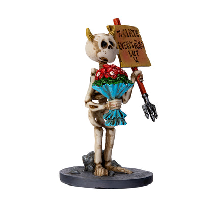 Right angle view of skeleton holding pitchfork and bouquet with humorous sign

