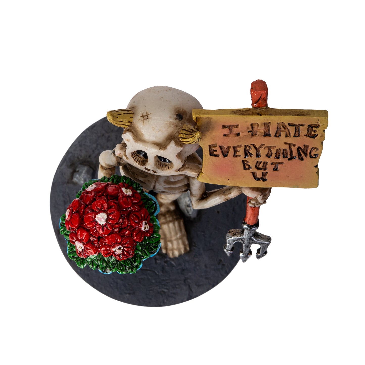 Top view of skeleton with bouquet and love message sign
