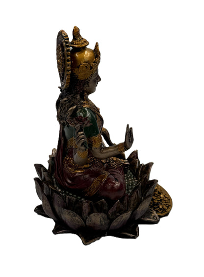 Side view of Lakshmi statue highlighting lotus pedestal and flowing garments with intricate accents
