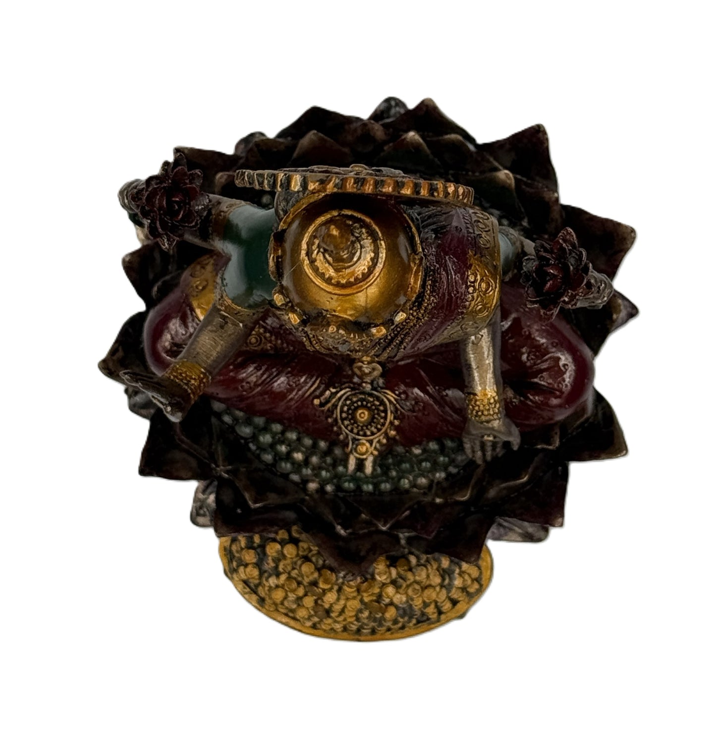 Top view of Lakshmi statue showing crown details, lotus base, and arrangement of gold coins beneath
