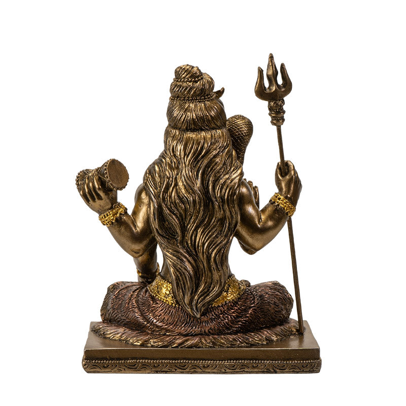 Back view of Shiva statue showing long hair detail and trident from behind
