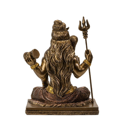 Back view of Shiva statue showing long hair detail and trident from behind
