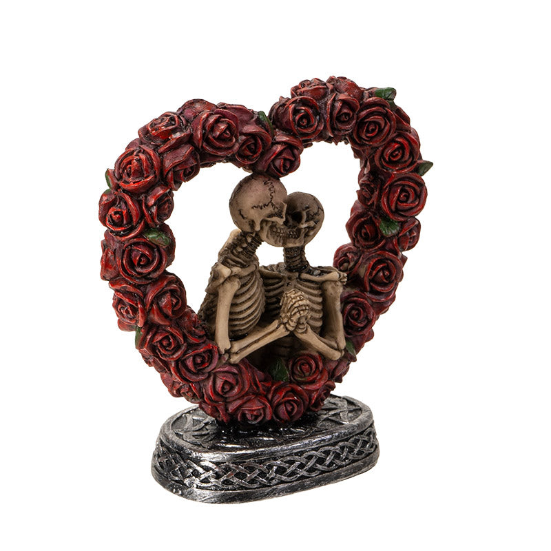 Angled view showcasing depth and romantic pose of skeleton couple
