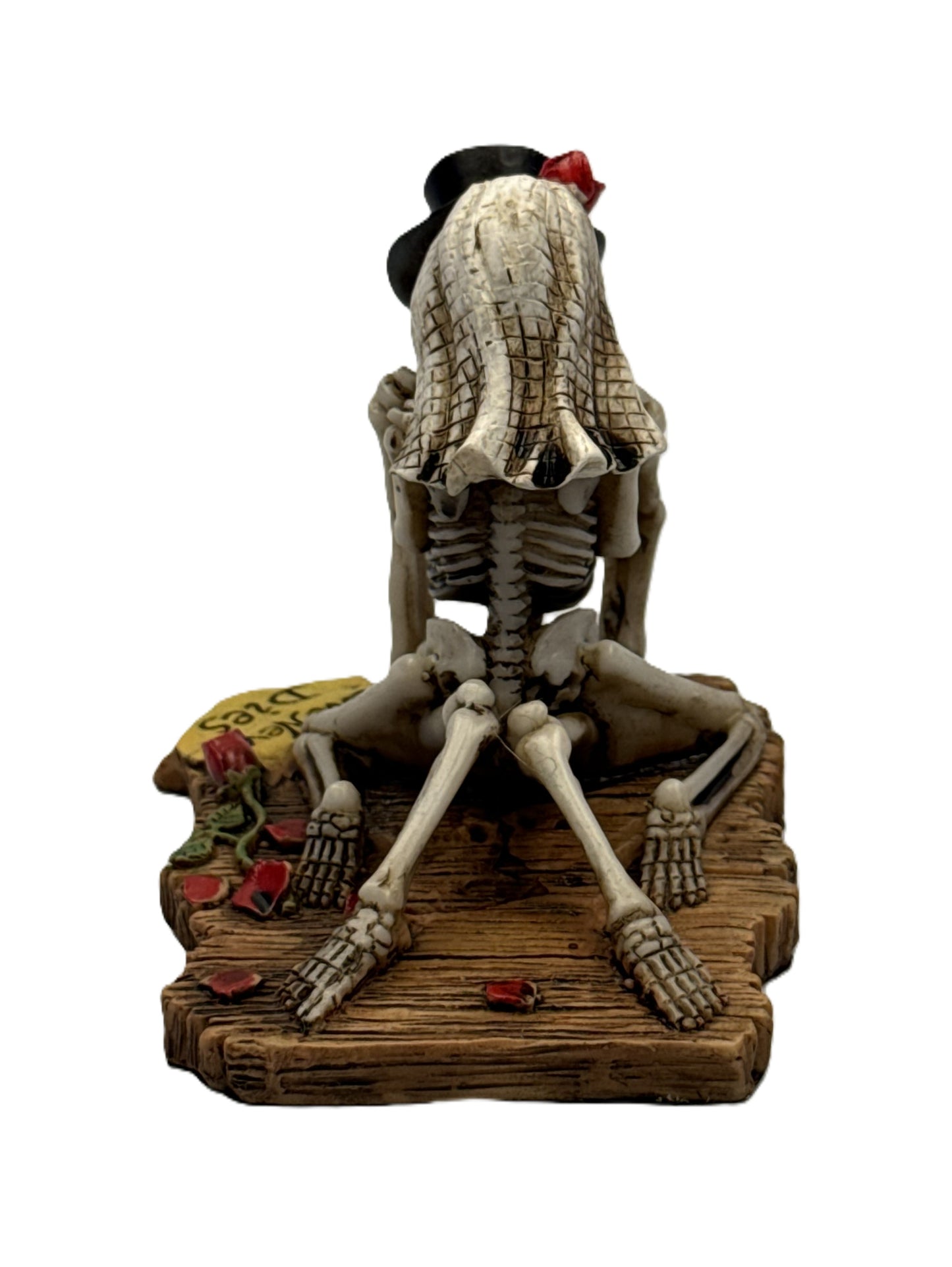 Back view of skeleton couple statue highlighting bride veil texture and seated pose on wooden base
