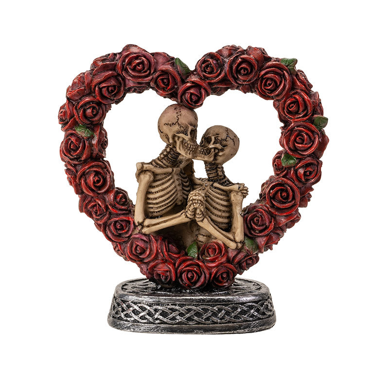 Front view of skeleton couple embracing inside red rose heart frame
