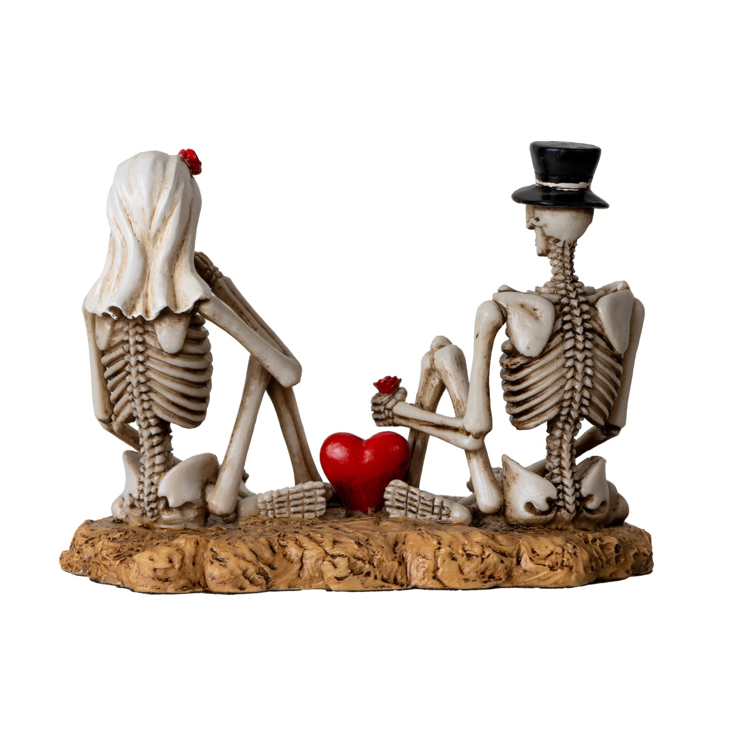 Back view of skeleton lovers figurine showing spine details and red heart centerpiece
