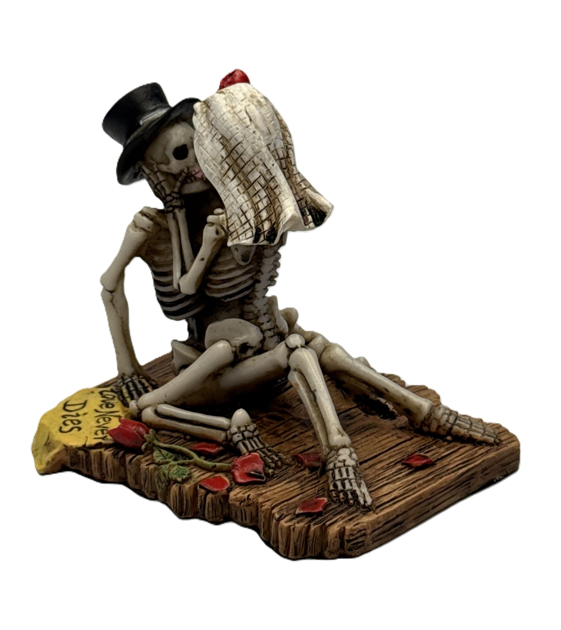 Side front view of romantic skeleton figurine showing bride veil groom hat and detailed bone structure
