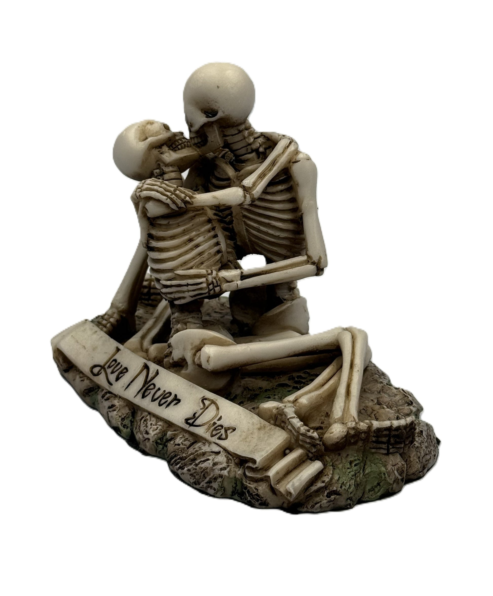 Angled view of romantic skeleton couple figurine sitting together with detailed bone structure and gothic base

