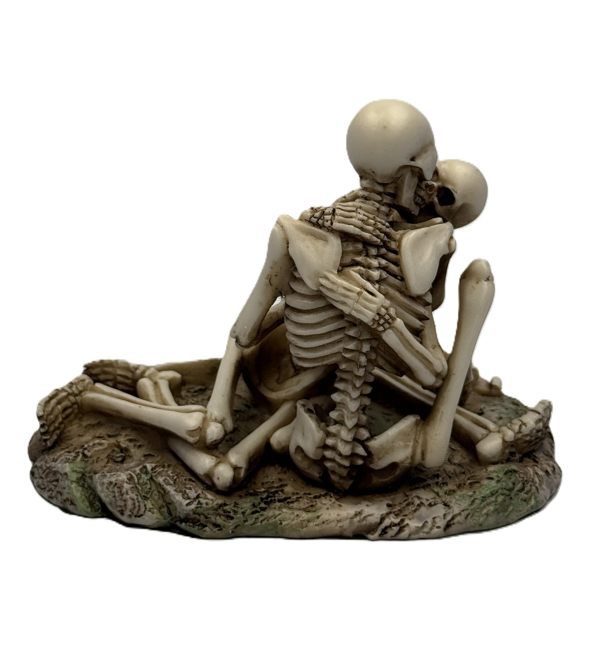 Back view of skeleton couple statue showing detailed spine and embrace posture on textured base
