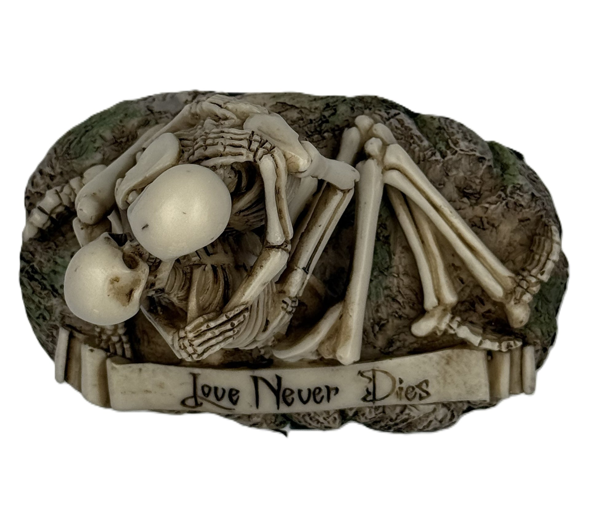 Top view of skeleton couple statue showing close embrace and Love Never Dies engraving on base
