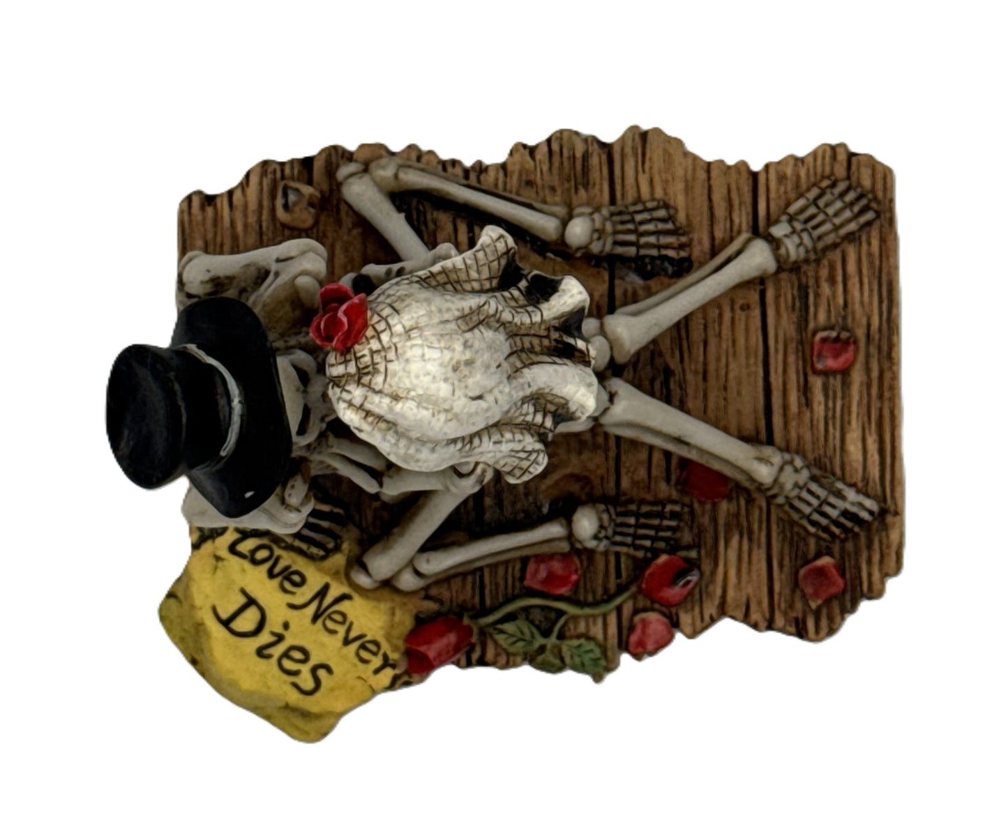 Top view of skeleton couple figurine with veil rose detail and wooden base engraved love never dies
