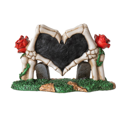 Back view of gothic skeleton hands heart figurine showing bone details and structure
