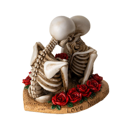 Back angled view of skeleton couple statue highlighting spine and rose details
