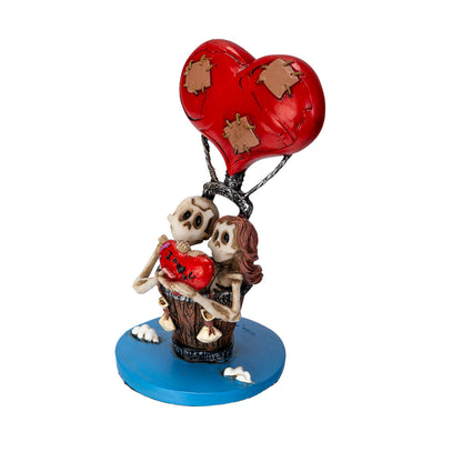 Left angle view of gothic skeleton couple with heart and balloon
