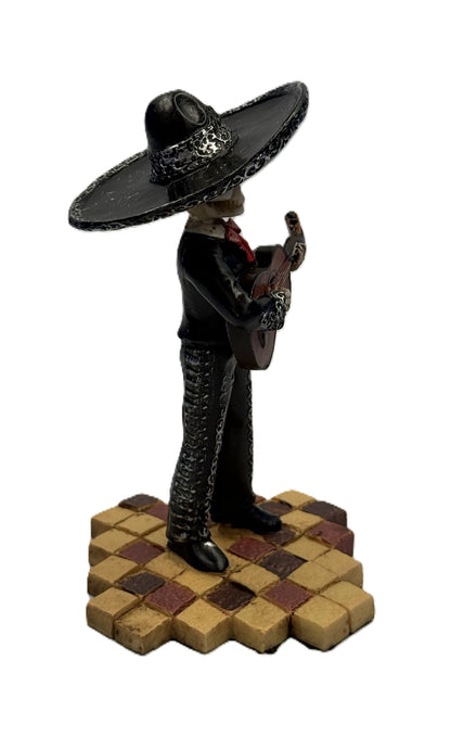 Angled view of Day of the Dead skeleton guitarist statue showing intricate detailing and pose

