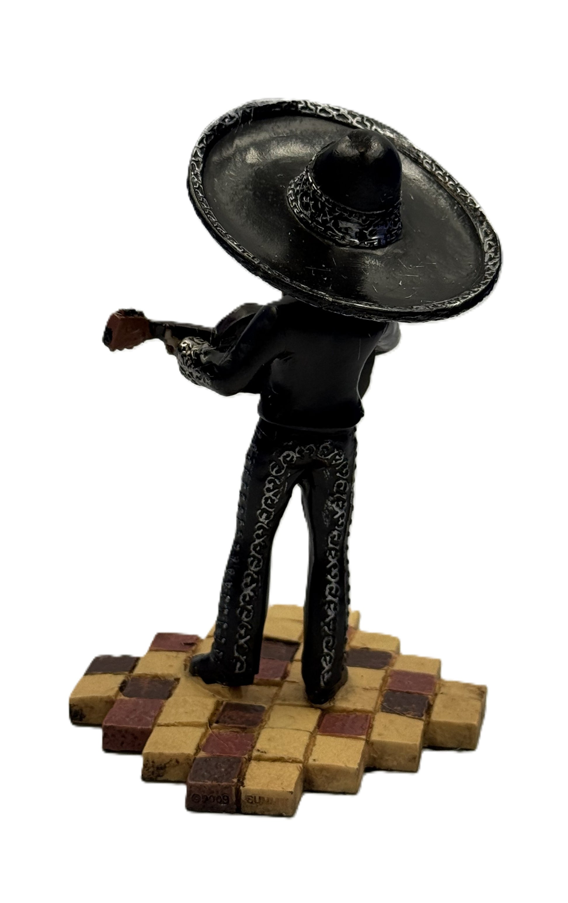 Back view of mariachi skeleton figurine highlighting sombrero and suit details with guitar
