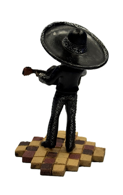 Back view of mariachi skeleton figurine highlighting sombrero and suit details with guitar

