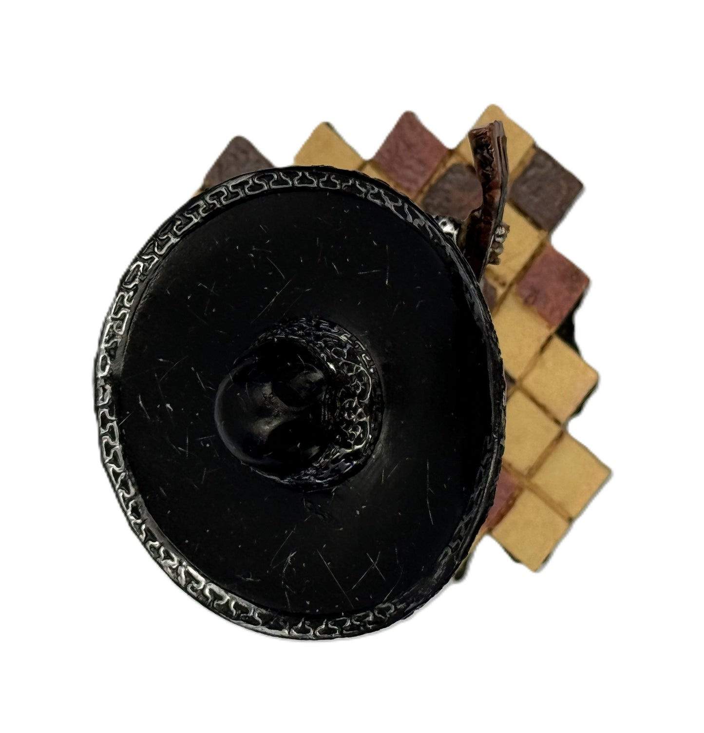 Top view of mariachi skeleton guitar figurine showing sombrero and tiled base pattern

