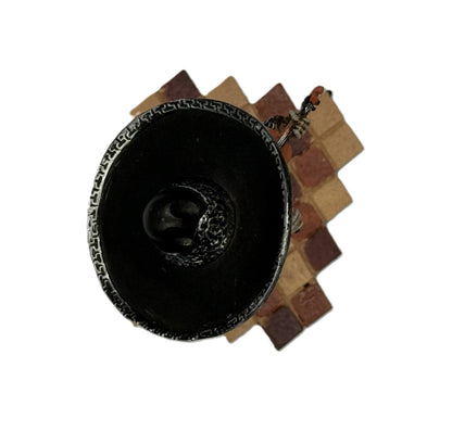 Top view of mariachi skeleton figurine showing sombrero and tiled base pattern
