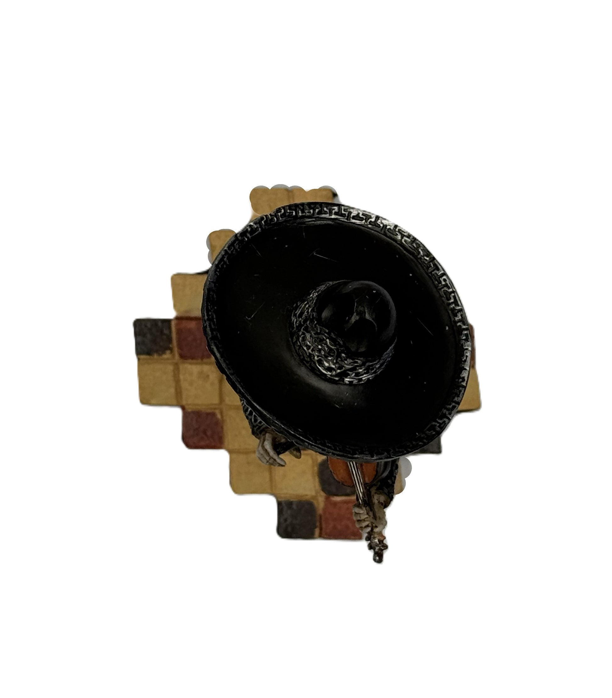 Top view of mariachi skeleton figurine showing sombrero and base tile pattern
