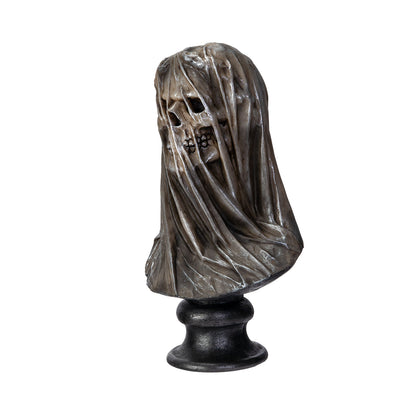 Side view of gothic veiled skull statue on pedestal base
