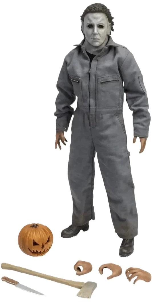 Front view of Michael Myers 1:6 scale figure with accessories including pumpkin, knife, and axe
