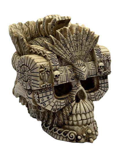 Angled view of Montezuma skull decor with layered feather crown and hand painted resin texture
