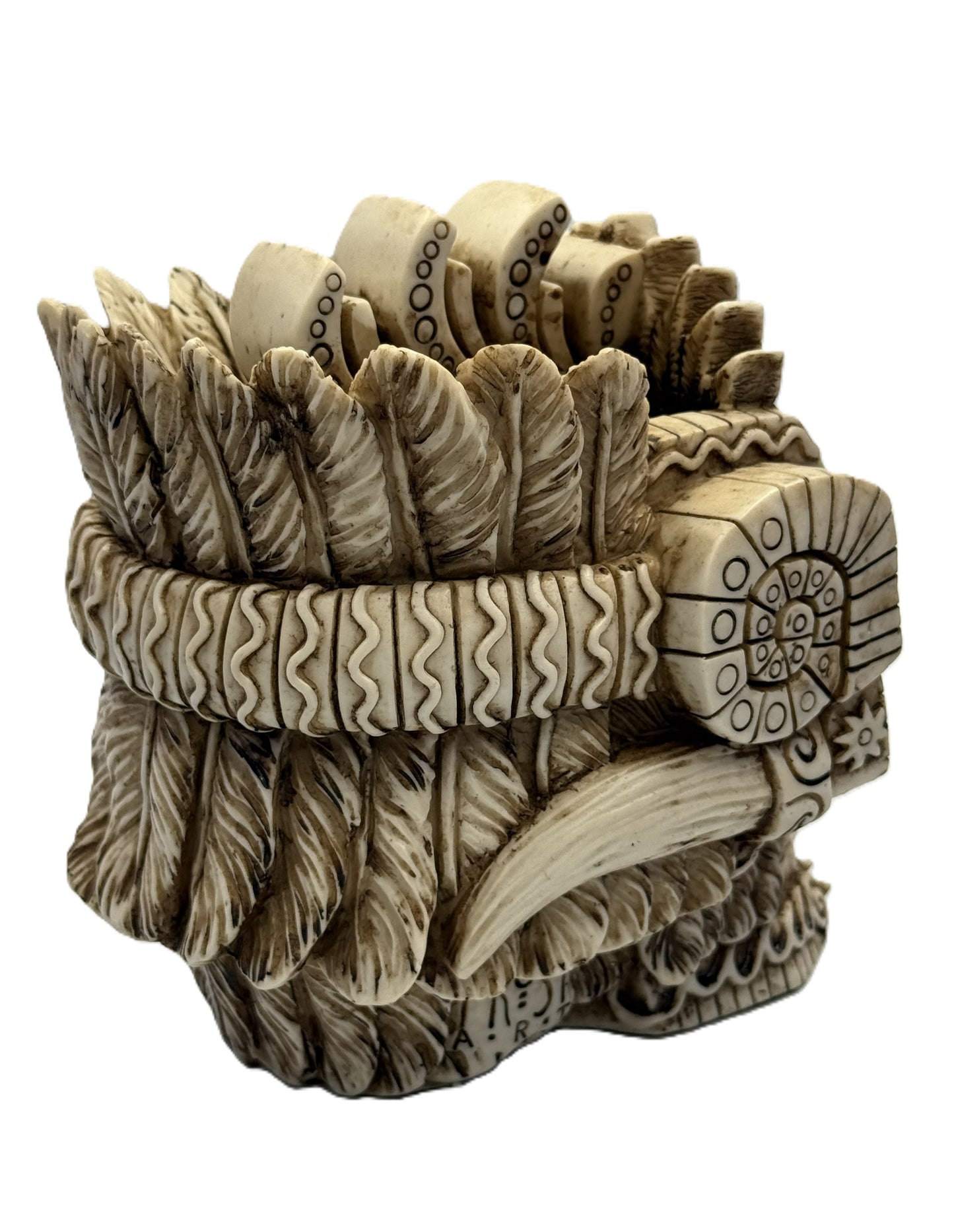 Rear angled view of Aztec skull decor highlighting feather textures and sculpted headdress structure
