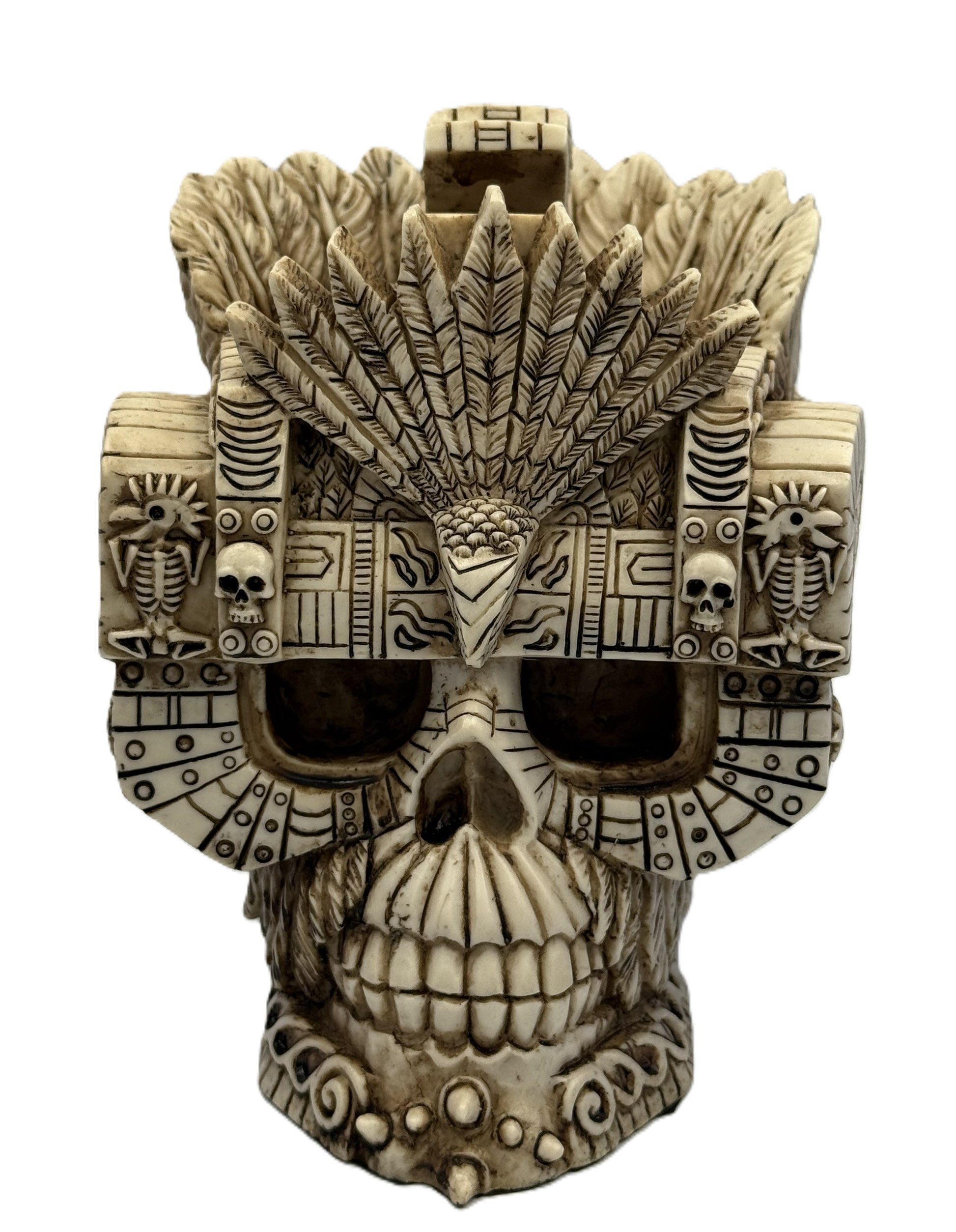 Front view of Aztec Montezuma skull statue with feathered headdress and intricate tribal carvings in bone finish
